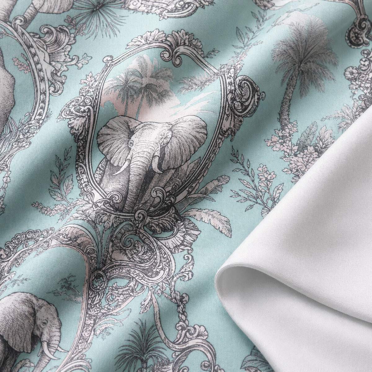 Macro close-up of the Animalia cotton sateen duvet fabric with elephant panel motif