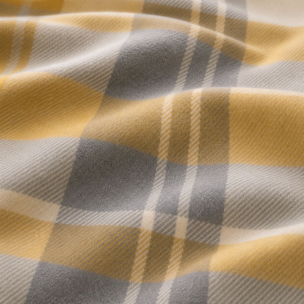 Macro close-up of the soft ochre and grey Colville Check brushed cotton flannelette fabric