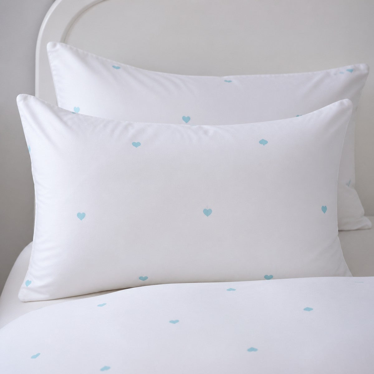 Close-up of Decorative Heart Duck Egg pillowcases with tiny duck egg blue heart motifs