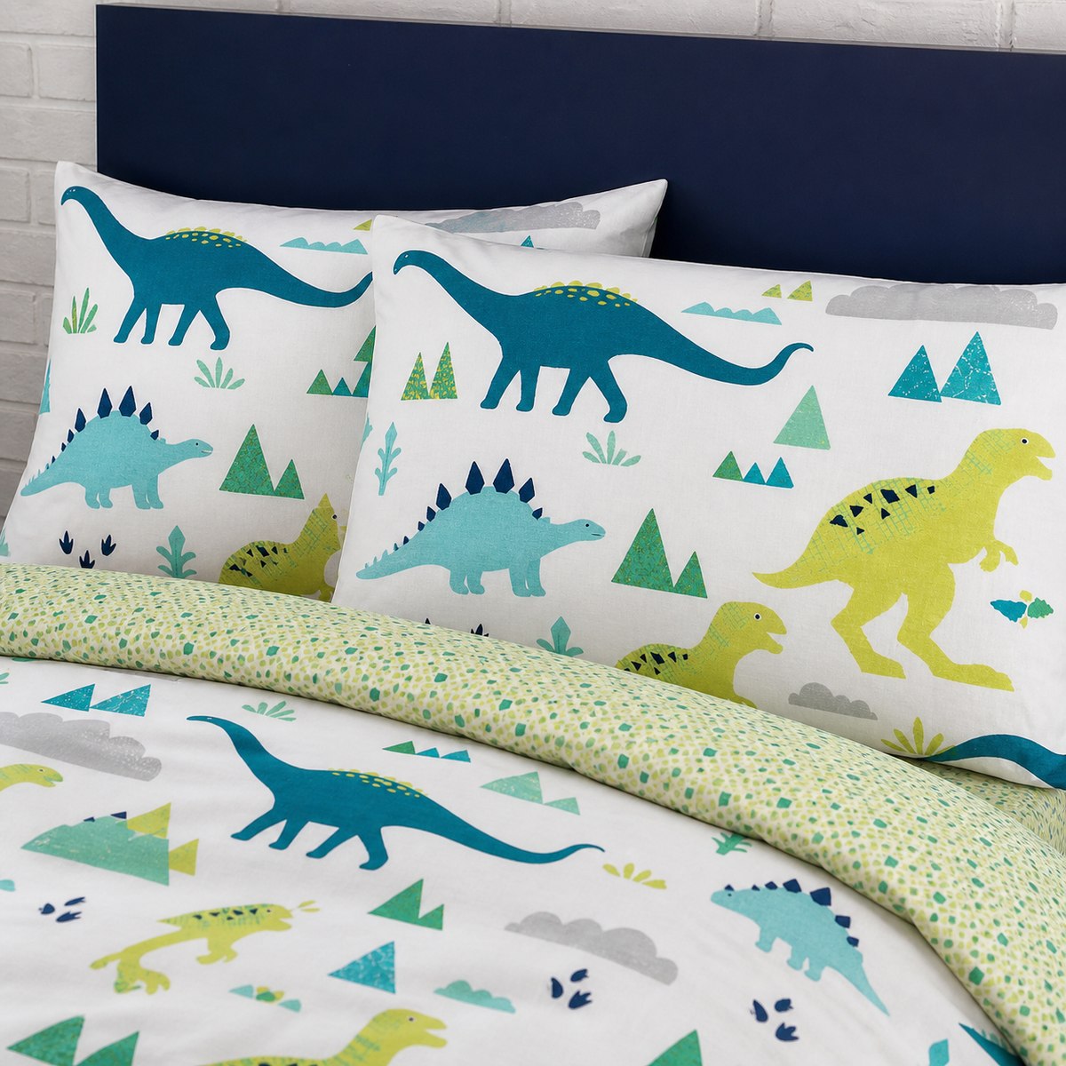 Close-up of matching Dino Dinosaur Kids Reversible Duvet Cover Set pillowcases showing the pattern and fabric detail