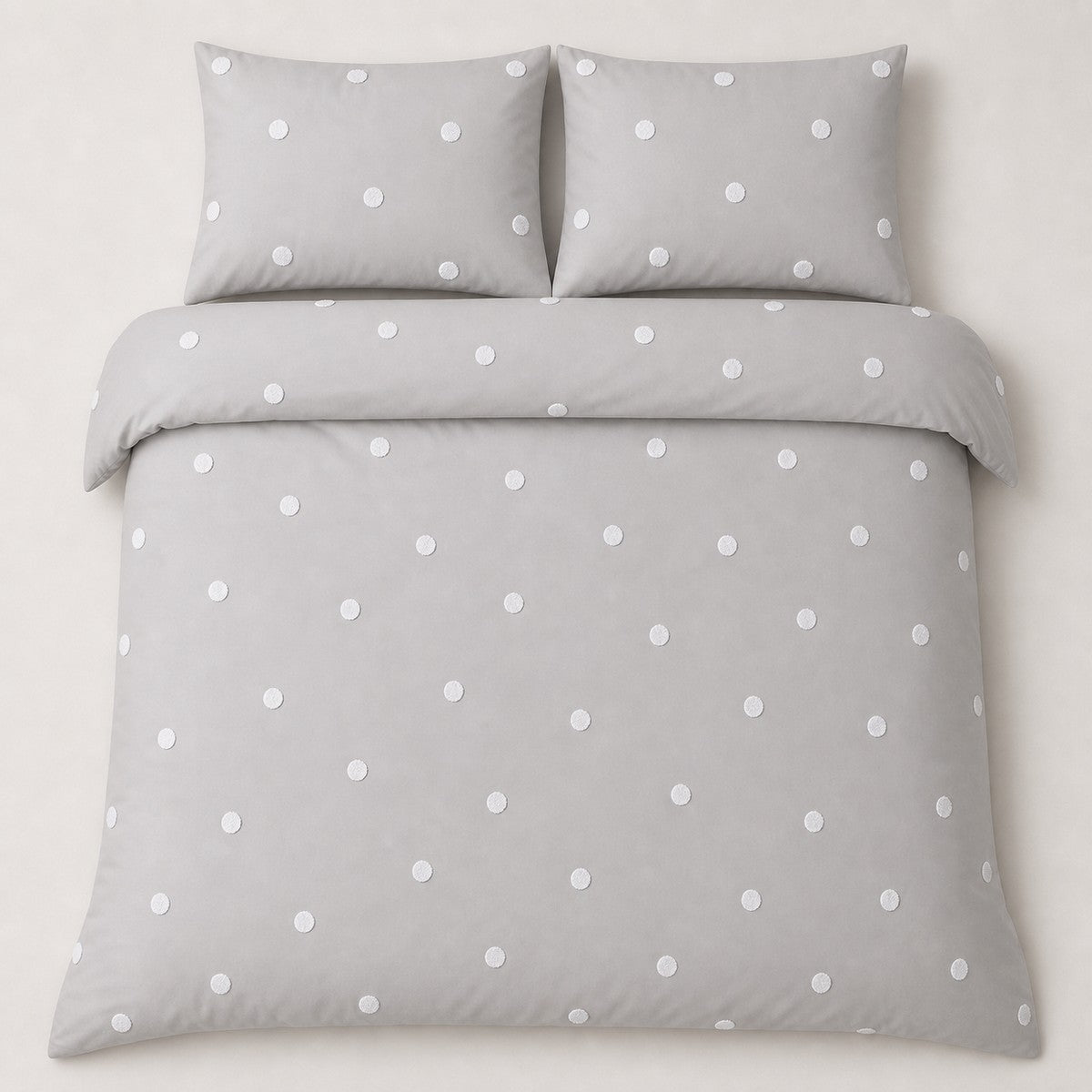 Overhead flat lay of the Dot Garden Cotton Duvet Cover Set in silver with two matching pillowcases