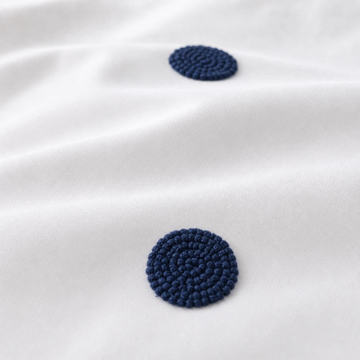Macro close-up of the white + navy fabric on the Dot Garden Cotton Duvet Cover Set