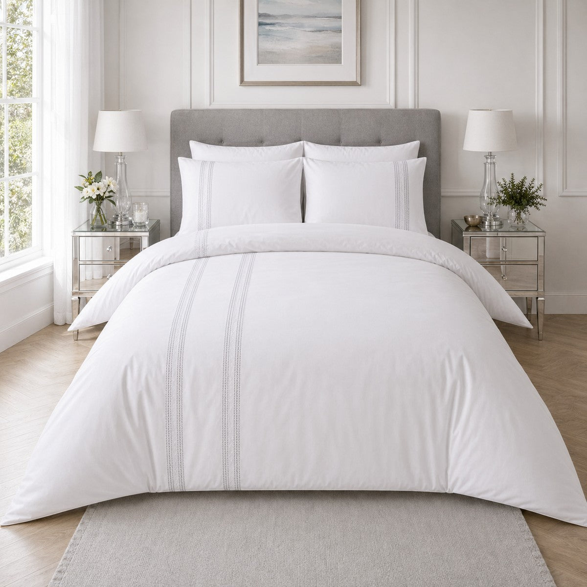 Embroidered Band silver cotton duvet cover set styled on a clean white bedroom bed