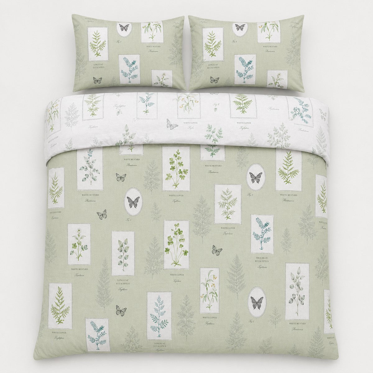 Overhead flat lay of the Floral Garden green reversible duvet cover set with two pillows