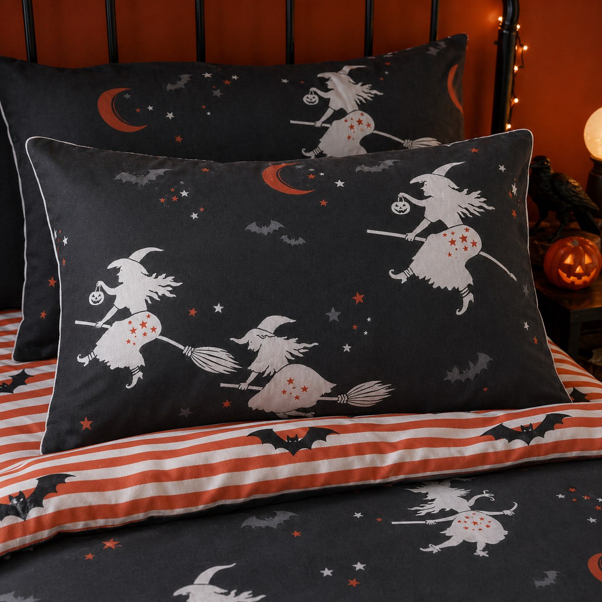 Close-up of Flying Witches Halloween pillowcases with witch moon and striped reverse design