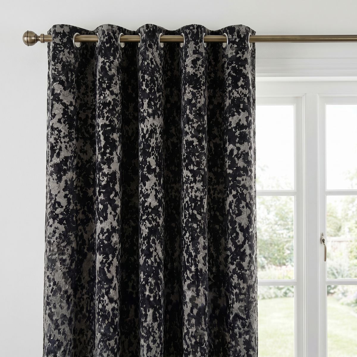 Close-up of the black Galaxy room darkening eyelet curtain showing the textured fabric and eyelet heading