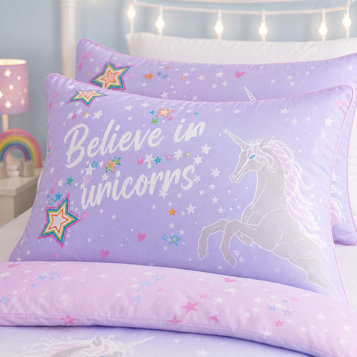 Close-up of the Ombre Unicorn lilac kids pillowcase with rainbow stars and unicorn print