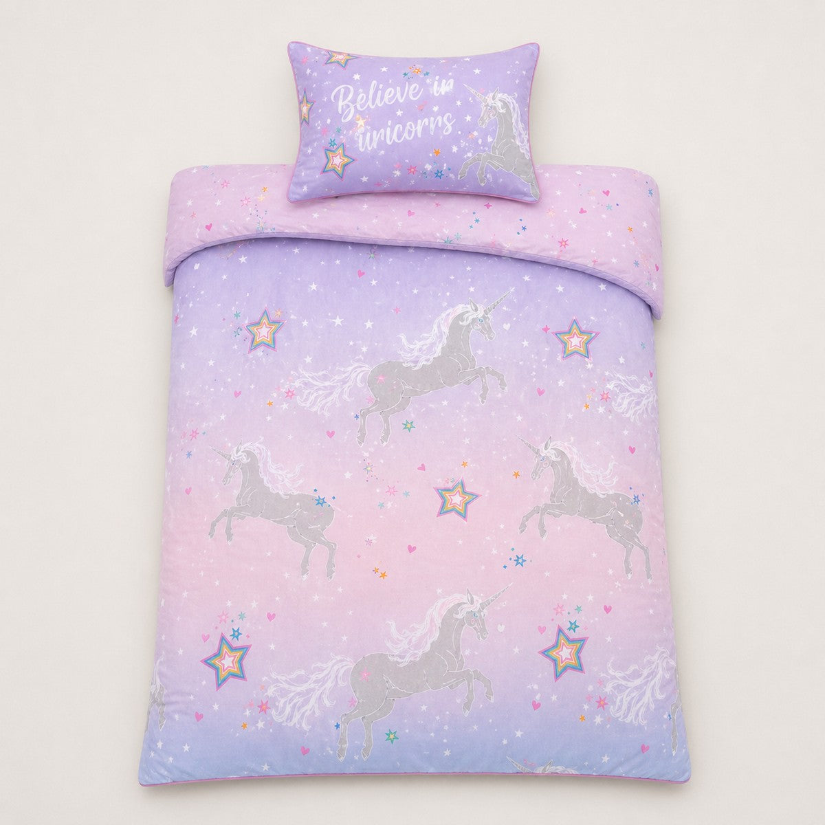 Overhead flat lay of the Ombre Unicorn lilac kids duvet cover set with matching pillowcase