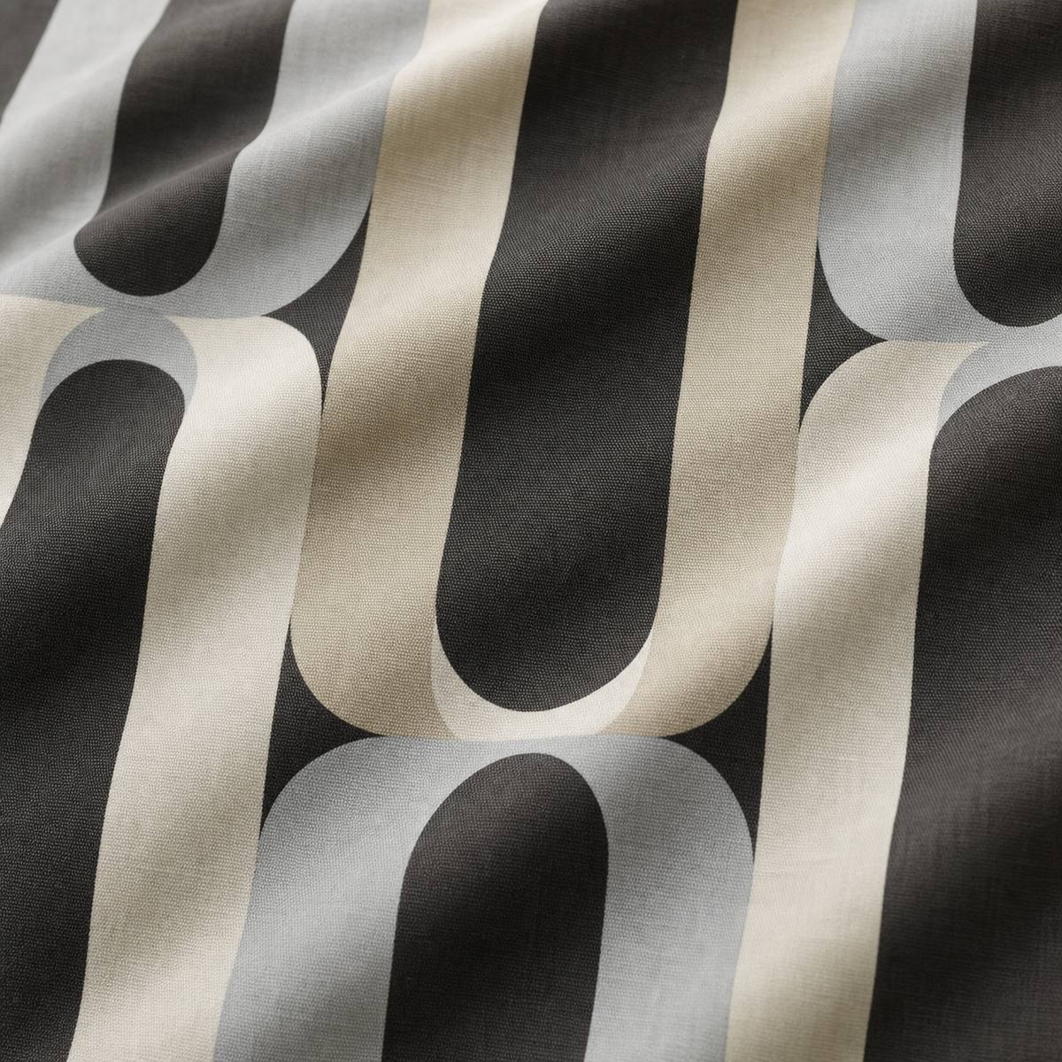Macro close-up of the charcoal grey and cream Orea polycotton duvet cover fabric