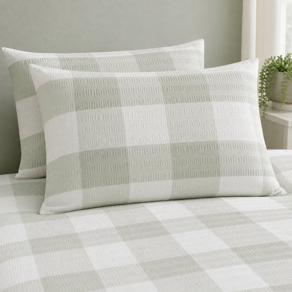 Close-up of Seersucker Gingham green pillowcases showing the raised puckered check texture