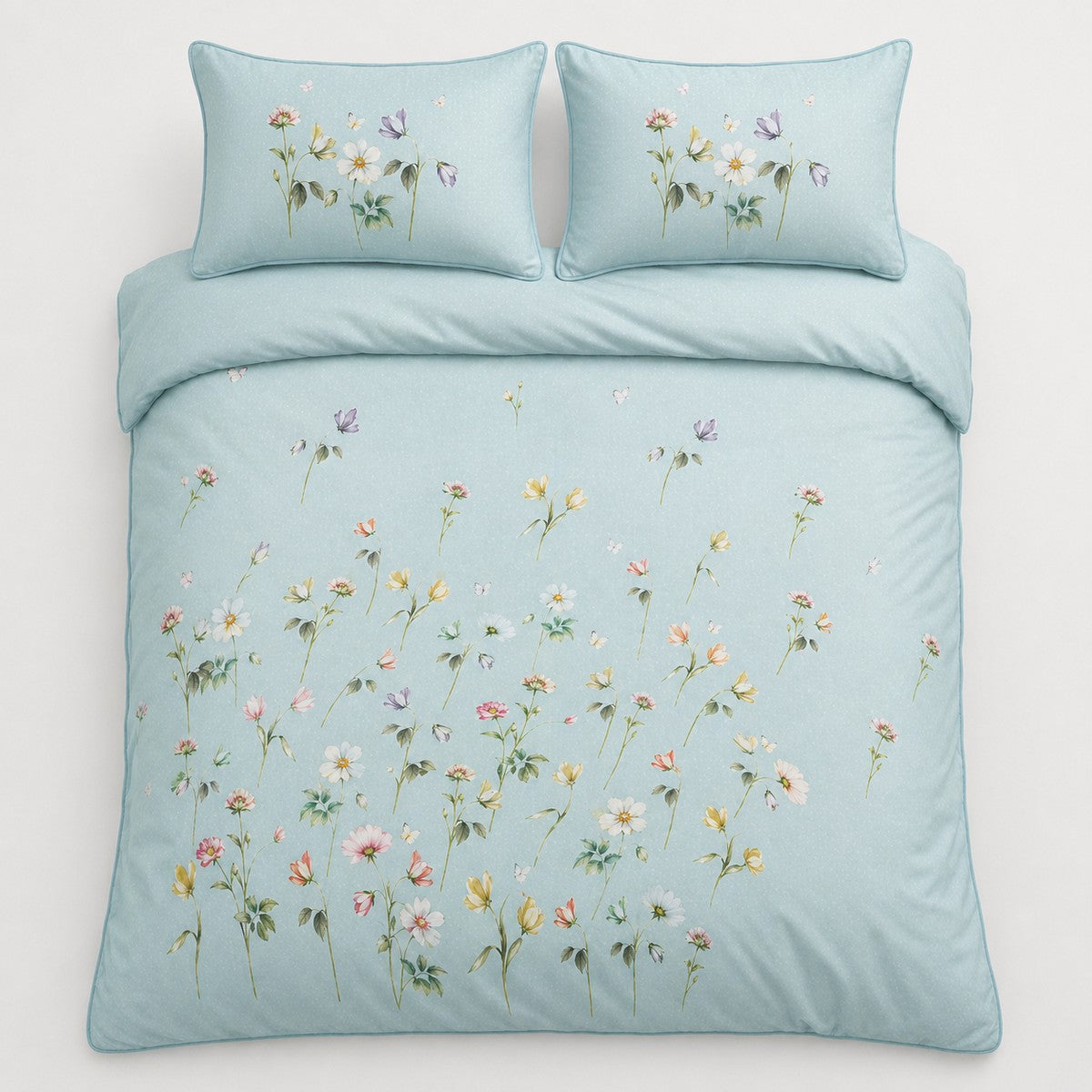 Overhead flat lay of Serenity duck egg floral duvet cover set with two pillows