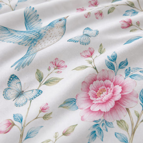 Macro close-up of the blue bird and pink floral Amelle polycotton duvet cover fabric