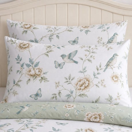 Close-up of Amelle Green pillowcases with the pale sage reversible duvet side folded below