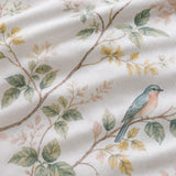Macro close-up of Arianna Natural cotton duvet cover fabric with bird and trailing floral detail