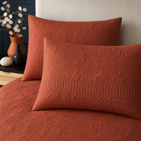 Close-up of Avery Stripe Terracotta pillowcases showing the raised floral and stripe texture