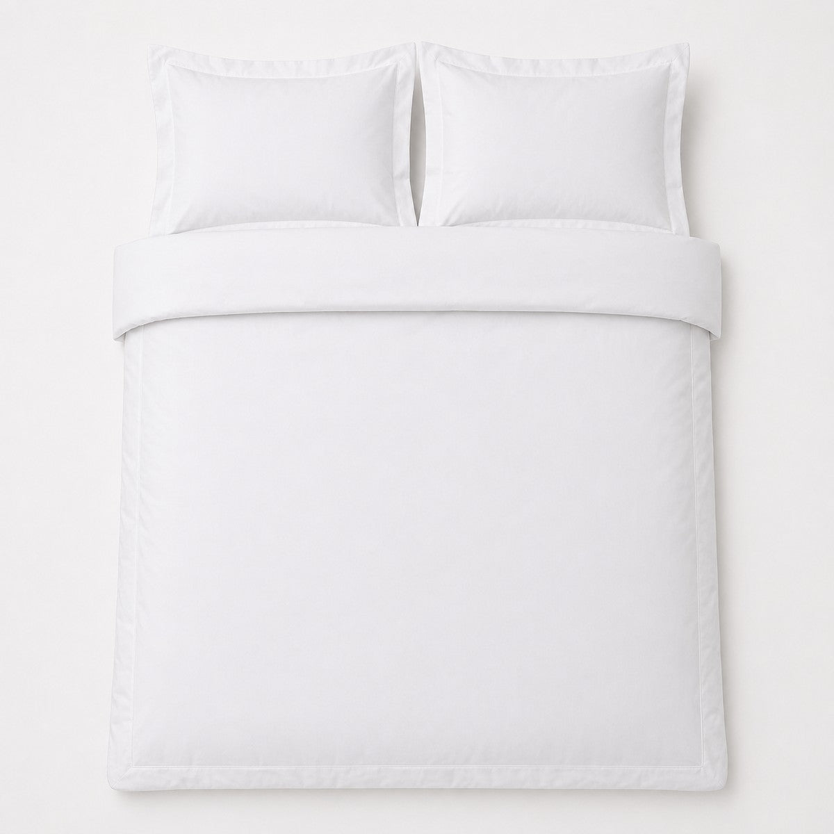 Overhead flat lay of the Baratta 100% Cotton White Duvet Cover Set with two matching pillowcases