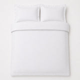 Overhead flat lay of the Baratta 100% Cotton White Duvet Cover Set with two matching pillowcases