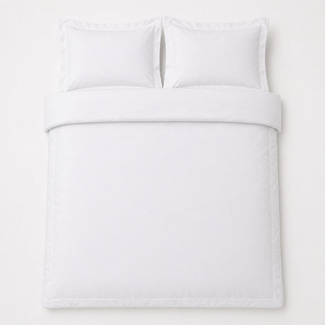 Overhead flat lay of the Baratta 100% Cotton White Duvet Cover Set with two matching pillowcases