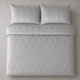 Overhead flat lay of the Belfort Velvet silver duvet cover set with two matching pillowcases