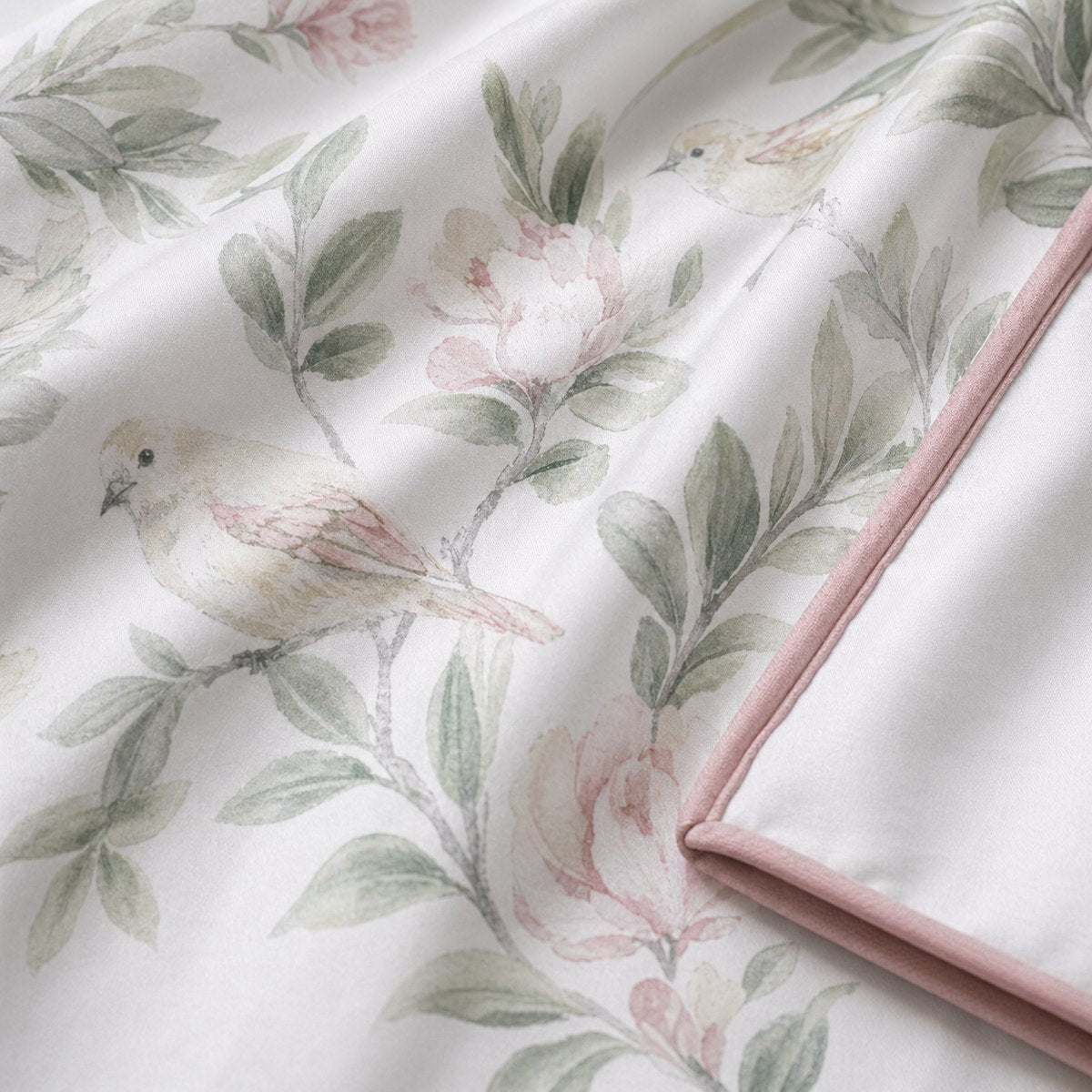 Macro close-up of Campion cotton sateen fabric with soft floral and bird motif