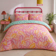 Carmen Pink cotton duvet cover set styled on a bright bedroom bed with teal reverse fold