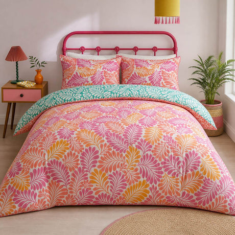 Carmen Pink cotton duvet cover set styled on a bright bedroom bed with teal reverse fold