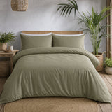 Cassia Khaki cotton duvet cover set styled in a calm natural bedroom