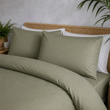 Close-up of Cassia Khaki cotton pillowcases showing the smooth plain fabric