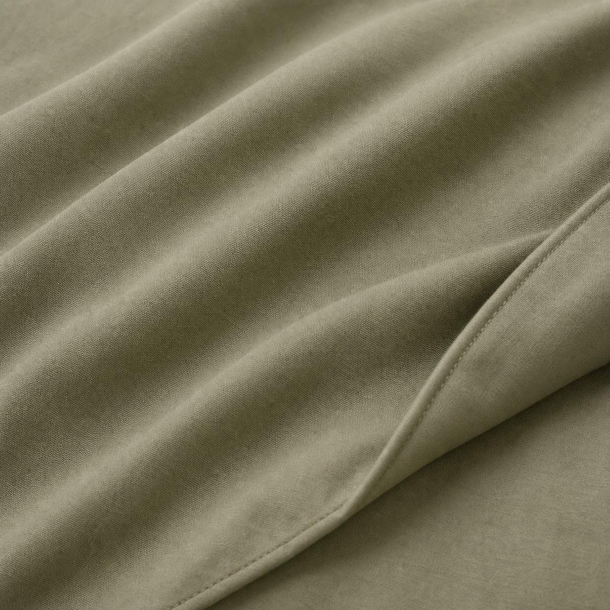 Macro close-up of Cassia Khaki cotton duvet cover fabric and subtle woven texture