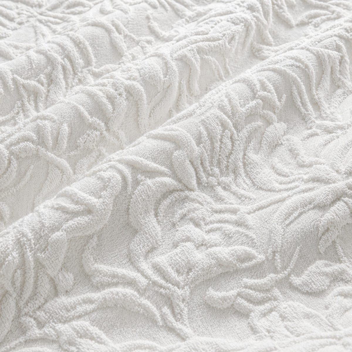 Macro close-up of the white Collier jacquard floral duvet cover fabric texture