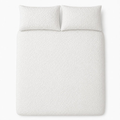 Overhead flat lay of the white Collier jacquard floral duvet cover set with two pillows