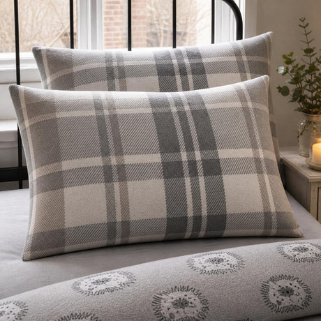 Close-up of Colville Check grey brushed cotton pillowcases showing the tartan pattern