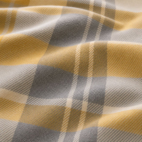 Macro close-up of the soft ochre and grey Colville Check brushed cotton flannelette fabric