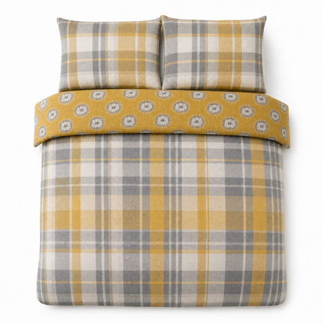 Overhead flat lay of the Colville Check ochre duvet cover set with two matching pillowcases