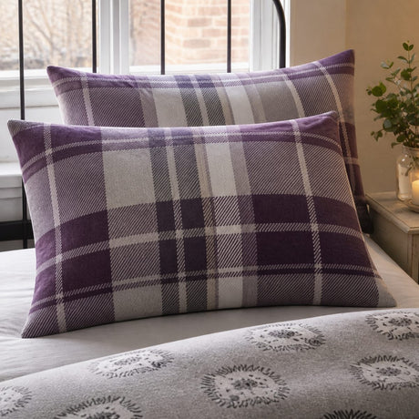 Close-up of Colville Check plum brushed cotton pillowcases showing the tartan pattern