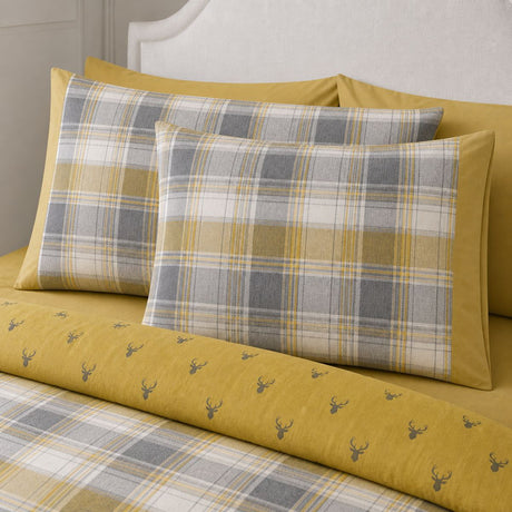 Close-up of Connolly ochre check brushed cotton pillowcases showing the tartan pattern