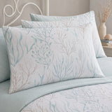 Close-up of Cora sea foam pillowcases showing coral branch and seaweed print detail
