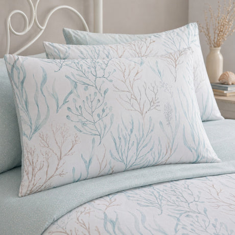 Close-up of Cora sea foam pillowcases showing coral branch and seaweed print detail