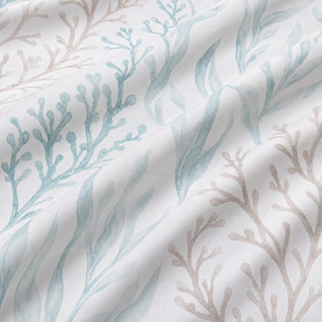 Macro close-up of the Cora sea foam duvet cover fabric with coral and underwater plant motifs