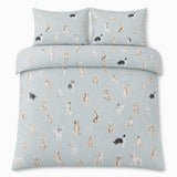 Overhead flat lay of the Cute Dogs Polycotton Duvet Cover Set with two matching pillowcases