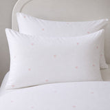Close-up of Decorative Heart Blush pillowcases with tiny blush pink heart motifs