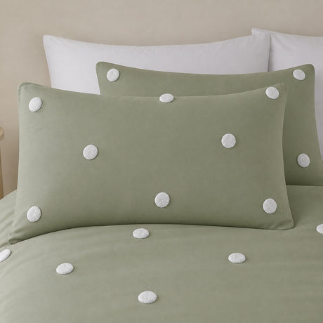 Close-up of Dot Garden sage cotton pillowcases with raised white dot detail