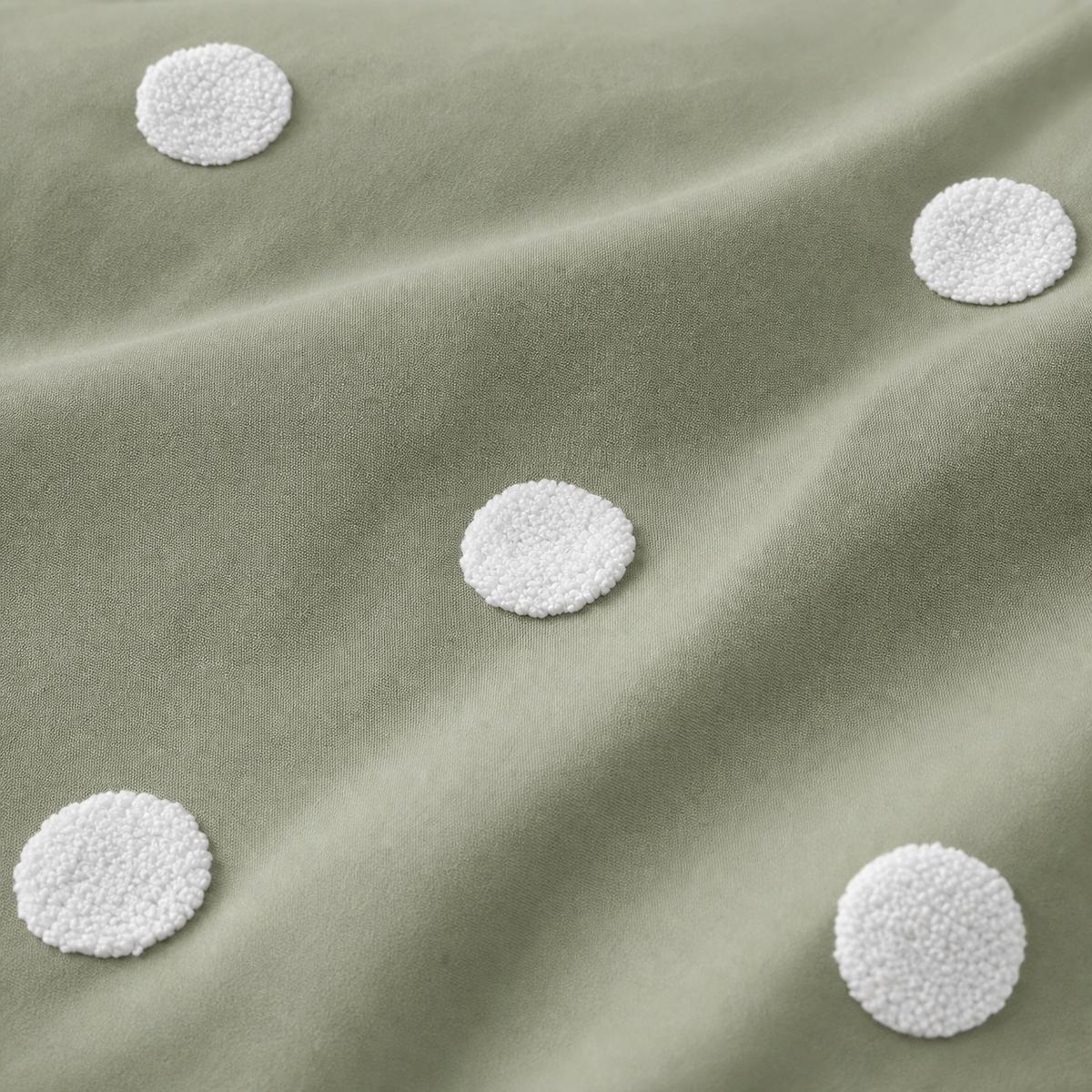 Macro close-up of the sage cotton fabric and raised white dots on the Dot Garden duvet cover