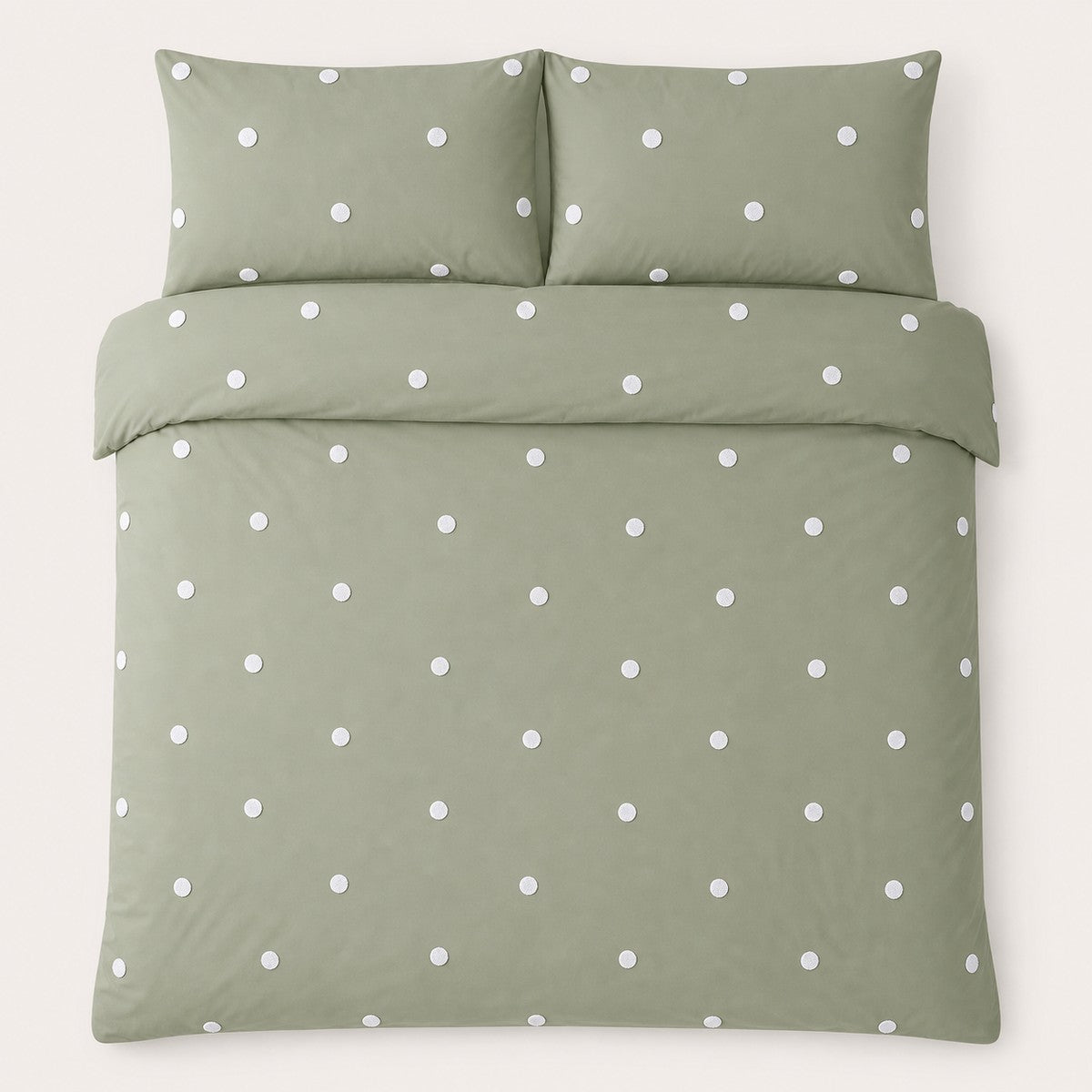Overhead flat lay of the Dot Garden sage duvet cover set with two matching pillowcases