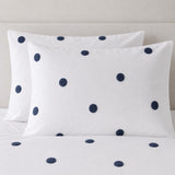 Close-up of Dot Garden Cotton Duvet Cover Set in white + navy pillowcases showing the print and fabric detail