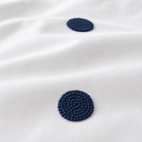 Macro close-up of the white + navy fabric on the Dot Garden Cotton Duvet Cover Set
