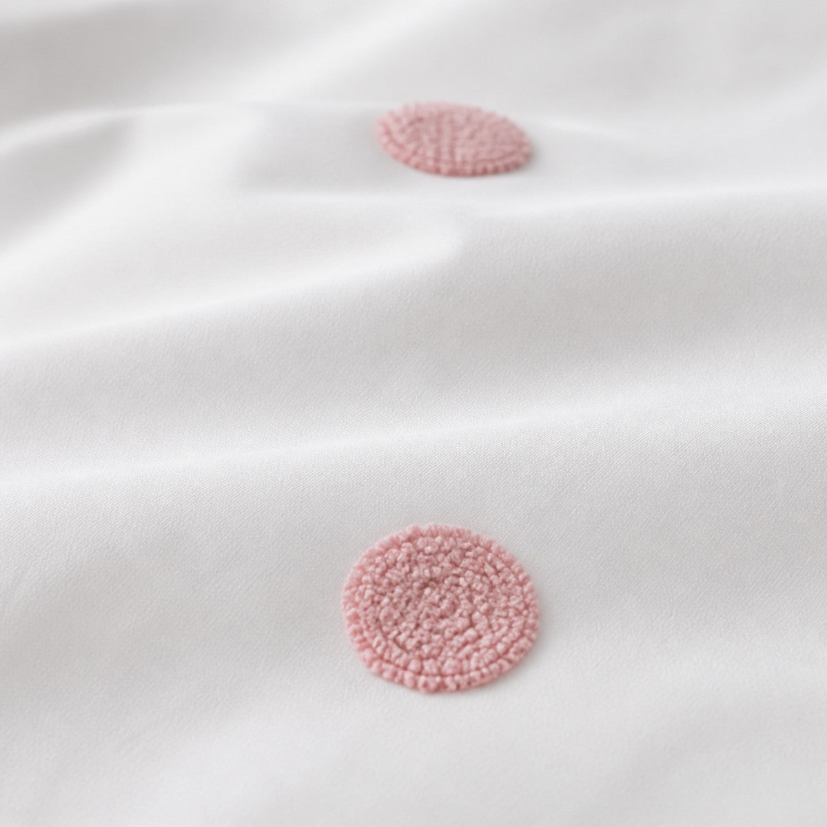 Macro close-up of the white + pink fabric on the Dot Garden Cotton Duvet Cover Set