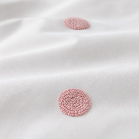 Macro close-up of the white + pink fabric on the Dot Garden Cotton Duvet Cover Set