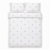 Overhead flat lay of the Dot Garden Cotton Duvet Cover Set in white + pink with two matching pillowcases