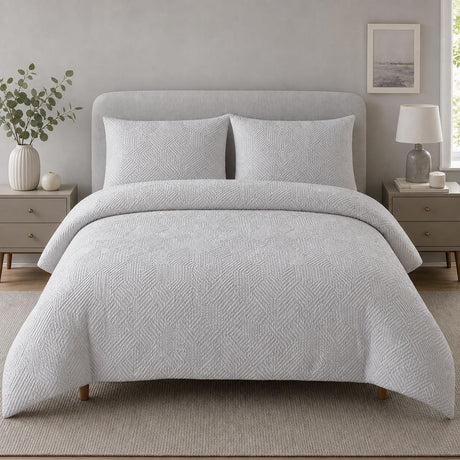 Embossed Geo Microfibre Duvet Cover Set in grey styled on a coordinated bedroom bed